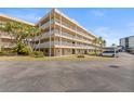 Multi-story condo building with spacious balconies, green spaces and covered parking at 9950 62Nd N Ter # 316, St Petersburg, FL 33708