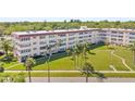 Beautifully landscaped condo complex with mature palm trees and well-manicured lawn at 9950 62Nd N Ter # 316, St Petersburg, FL 33708