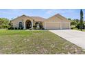 Beautiful exterior featuring a lush lawn, decorative fountain and a spacious three car garage at 5202 Lydia Ct, Spring Hill, FL 34608