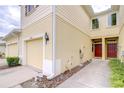 Street view of the townhome's front entry and garage, featuring well-manicured landscaping at 10822 Verawood Dr, Riverview, FL 33579