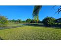 Enjoy this oversized backyard featuring a serene pond, mature trees and wrought iron fence at 11412 Autumn Leaf Way, Bradenton, FL 34212