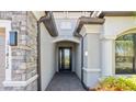 Stunning home entryway featuring stone accents and an inviting covered porch at 11412 Autumn Leaf Way, Bradenton, FL 34212