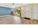 A spacious living room features new wood-look floors, large window with natural light, and neutral wall colors at 1250 12Th Sw Ct, Largo, FL 33770