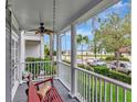 Inviting front porch with a swing, ceiling fan, and views of the street and neighborhood at 1403 W Watrous Ave, Tampa, FL 33606