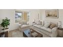 Inviting living room with neutral furniture, decorative pillows, and a view of the front yard at 1805 Granville Ln, Sun City Center, FL 33573