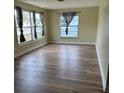 Bright living room with hardwood floors and large windows providing natural light at 1809 Driftwood N Cir, Oldsmar, FL 34677