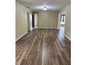 Living room showcasing wood-look flooring and an open floor plan at 1809 Driftwood N Cir, Oldsmar, FL 34677