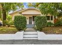 Charming bungalow-style home with lush trees, manicured shrubs, and a welcoming front entrance at 3411 N 12Th St, Tampa, FL 33605