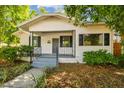Lovely bungalow-style home with a quaint front porch, iron railings, and beautiful landscaping at 3411 N 12Th St, Tampa, FL 33605