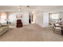 Comfortable living area with seating, neutral decor and a view into the kitchen and dining area at 34150 Estates Ln, Wesley Chapel, FL 33543