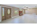 Spacious living room featuring a decorative fireplace, ceiling fans, and light tile floors at 3572 Pocahontas Dr, Largo, FL 33774
