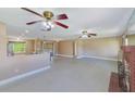 Bright living space with neutral walls, ceiling fans, fireplace and access to kitchen at 3572 Pocahontas Dr, Largo, FL 33774