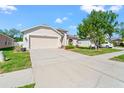 Lovely home featuring an attached garage, a well-manicured lawn, and sidewalk leading to the front door at 4247 Balmoral Ct, Wesley Chapel, FL 33543
