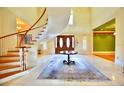 Grand foyer with a winding staircase, high ceilings, and elegant tile flooring at 441 Lucerne Ave, Tampa, FL 33606