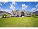 Charming one-story home featuring lush lawn and attractive landscaping at 5214 Lake Venice Dr, Wimauma, FL 33598
