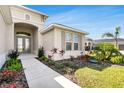 Charming home exterior with a concrete walkway and lush landscaping showcasing curb appeal at 5214 Lake Venice Dr, Wimauma, FL 33598