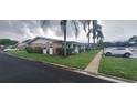 A side view of well-kept condo exteriors, showcasing landscaping and parking at 605 Brandy Wine Dr # 605, Largo, FL 33771