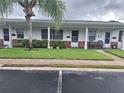 Street view of condos with well-maintained lawns and charming brick-accented facades at 605 Brandy Wine Dr # 605, Largo, FL 33771