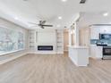 Modern living room boasts built-in shelves, fireplace, and an open design with a view into the adjacent kitchen at 623 15Th Nw Ave, Largo, FL 33770