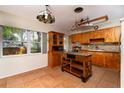 Cozy kitchen features a charming island, tile floors, and wooden cabinetry at 6801 5Th N St, St Petersburg, FL 33702