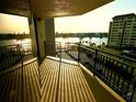 Scenic balcony view overlooking the water with a glimpse of the sunset and nearby buildings at 690 Island Way # 707, Clearwater Beach, FL 33767