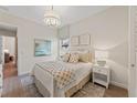This bedroom is decorated with a plush bed, ambient lighting, and stylish wall art at 8118 Thruso Rd, Port Charlotte, FL 33981