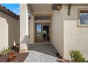 Elegant entryway with a stylish front door, stone walkway, and manicured landscaping at 8118 Thruso Rd, Port Charlotte, FL 33981