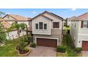 A charming home showcases a brick driveway, two-car garage, and meticulously landscaped front yard at 935 Terra Vista St, Brandon, FL 33511