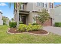Well-maintained front yard featuring mature landscaping, a vibrant lawn, and manicured shrubs at 935 Terra Vista St, Brandon, FL 33511