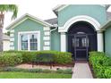 Inviting front entrance with beautiful landscaping and a cozy bench at 10118 Cleghorn Dr, San Antonio, FL 33576