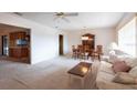 Spacious living room with neutral carpet leading into the dining area and kitchen at 103 El Turco Ct, Sun City Center, FL 33573