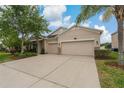 Charming single Gathering home featuring a well-manicured lawn and a spacious two car garage at 10734 Breaking Rocks Dr, Tampa, FL 33647