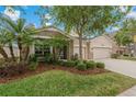 Charming single Gathering home featuring a well-manicured lawn and a spacious two car garage at 10734 Breaking Rocks Dr, Tampa, FL 33647