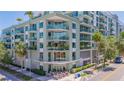 A contemporary building featuring a cafe, balconies, and lush landscaping at 111 N 12Th St # 1614, Tampa, FL 33602