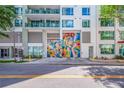 Street-level view of modern building with vibrant mural on a garage door at 111 N 12Th St # 1614, Tampa, FL 33602