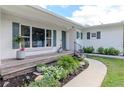 Inviting front porch with a stained wood landing and lush landscaping, enhancing curb appeal at 125 Siobhan Ave, Tampa, FL 33613