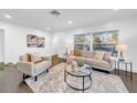 Bright living room with hardwood floors, a modern sofa, and an abundance of natural light at 136 30Th N Ave, St Petersburg, FL 33704