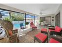 Screened lanai offering comfortable seating and a view of the refreshing in-ground pool, perfect for relaxing and entertaining at 1472 Overland Dr, Spring Hill, FL 34608