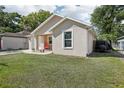 Side view of a cozy single-story home with a well-maintained lawn and private backyard at 1614 E Nome St, Tampa, FL 33604