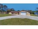 Beautiful home with a detached garage and concrete driveway, offering ample space and great curb appeal at 16247 Fringe Tree Dr, Spring Hill, FL 34610