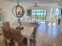 Inviting living space with coastal decor, dining area, and stunning water views at 1720 Lighthouse S Ter # 8, South Pasadena, FL 33707