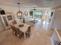 Inviting living space with coastal decor, dining area, and stunning water views at 1720 Lighthouse S Ter # 8, South Pasadena, FL 33707