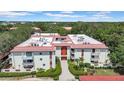 An aerial view of the building, showing lush surroundings and a well-maintained roof at 2612 Pearce Dr # 209, Clearwater, FL 33764