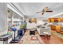 Bright living room with hardwood floors, a comfortable sofa, and a view of the outside at 2612 Pearce Dr # 209, Clearwater, FL 33764