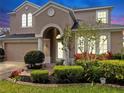 Two-story home with well-kept landscaping, an arched entryway, and an attached two-car garage at 312 Taxter Run Ln, Valrico, FL 33594