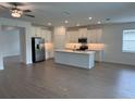 Open-concept kitchen featuring a center island, stainless steel appliances, and ample counter space at 31753 Griffin Sands Ln, San Antonio, FL 33576