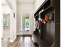 Bright entryway boasts wood-look tile flooring, an arched doorway and a stylish mudroom bench at 3822 Balcony Breeze Dr, Land O Lakes, FL 34638
