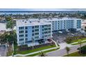 Modern condo complex featuring private patios, covered parking, and lush landscaping at 415 Island Way # 205, Clearwater Beach, FL 33767