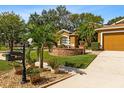 Charming house highlighting lush landscaping, a lovely fountain, and meticulous lawn care at 4508 Compass Oaks Dr, Valrico, FL 33596