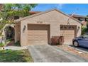Charming townhouse featuring a two-car garage, landscaped yard, and inviting curb appeal at 4733 W Vasconia St, Tampa, FL 33629